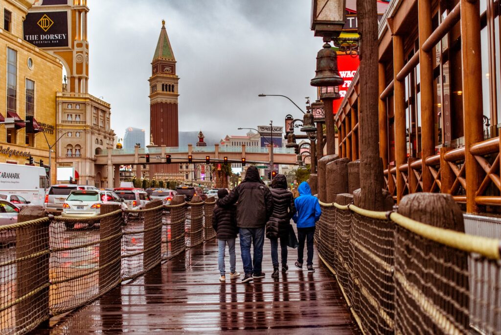 Family walking together in rain through city