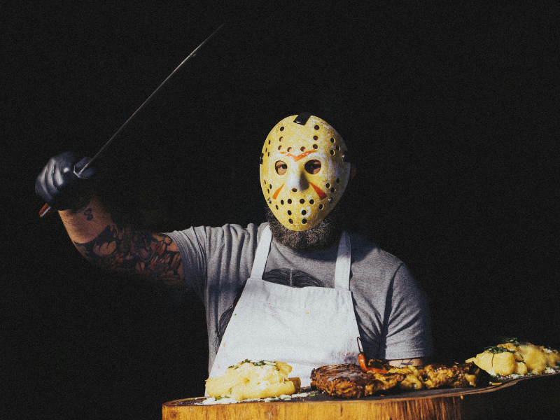 Man in butcher costume with meat board