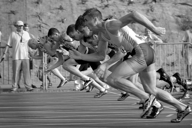 Athletes running on track and field - black and white photography