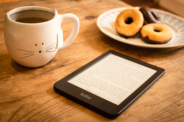 Reading tablet, coffee and doughnuts